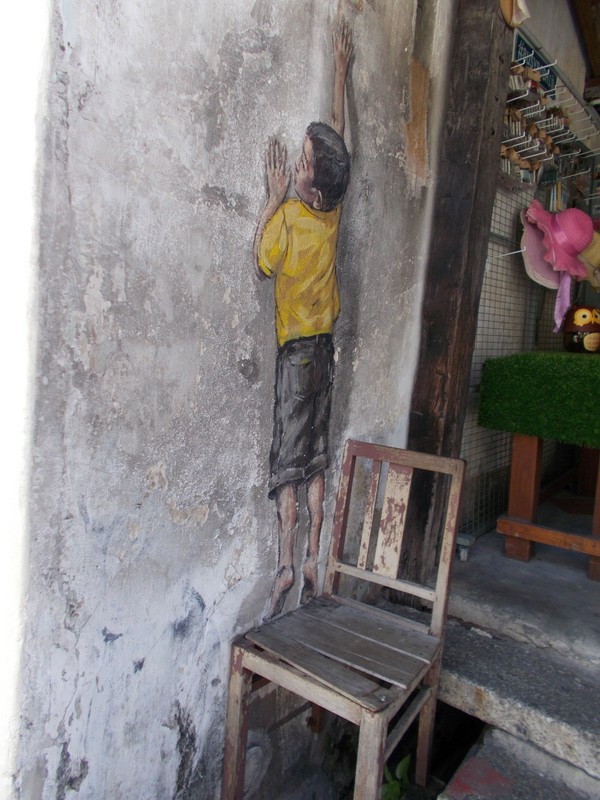Boy on chair by Ernest Zacharevic, Georgetown, Penang, Malaysia.